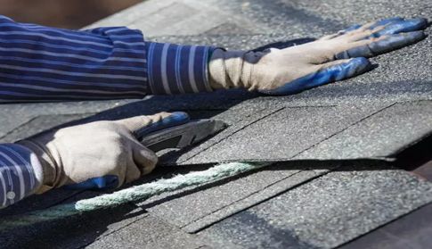 roofer putting on shingles