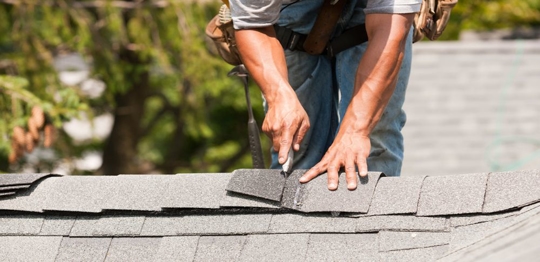 roofer putting on shingles