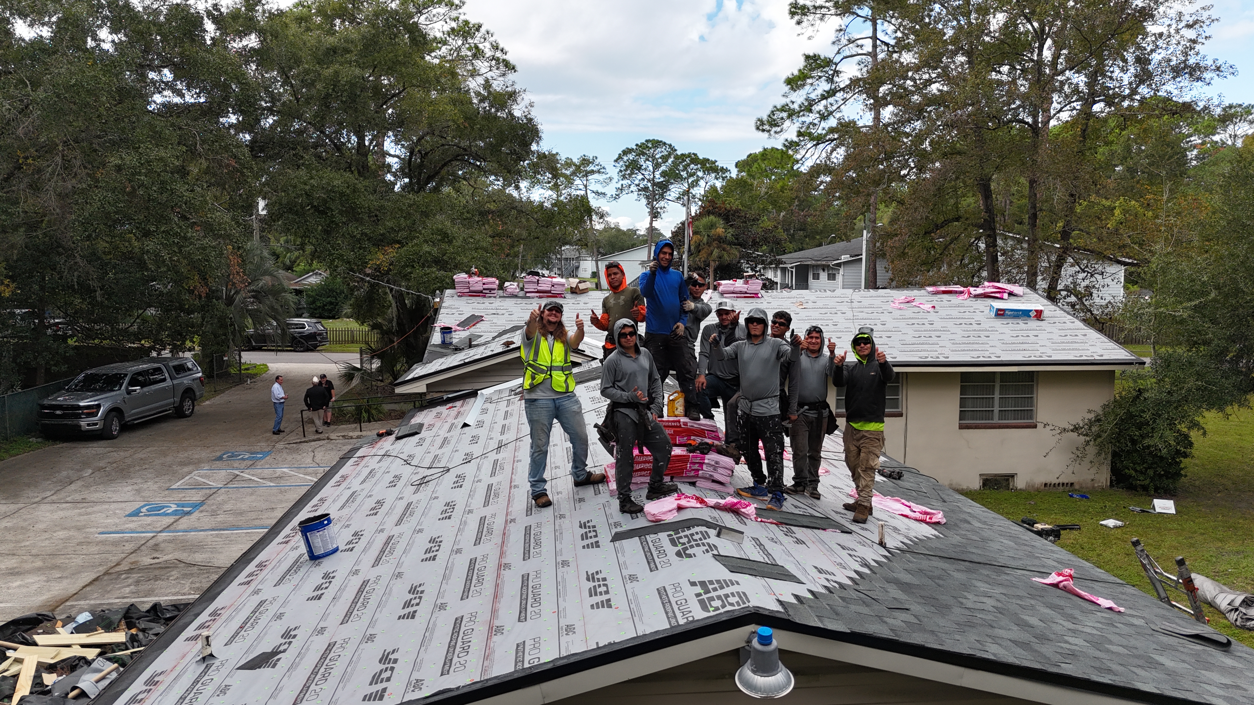 The team standing on a roof for the Disabled Veterans Association